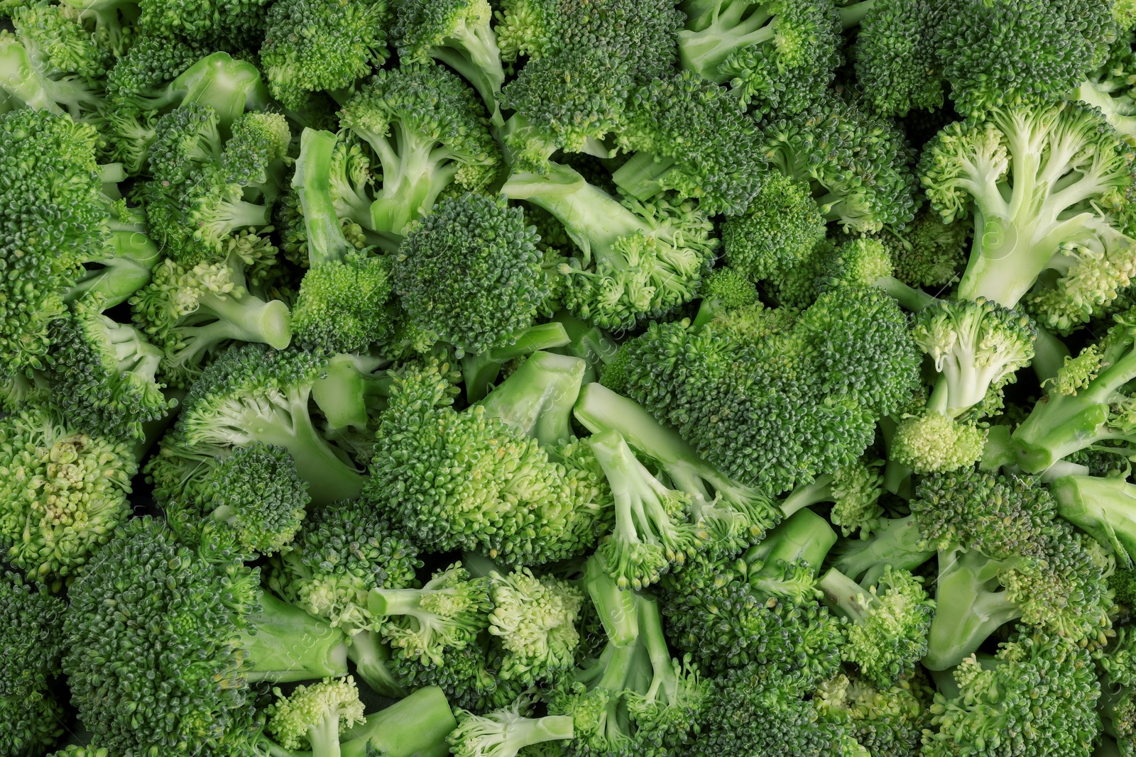 Photo of Fresh raw broccoli as background, top view