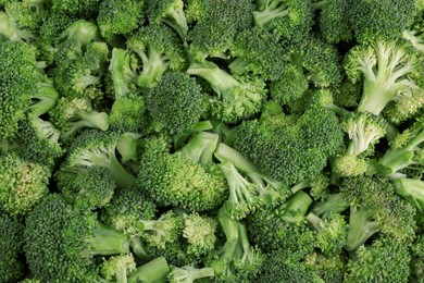 Photo of Fresh raw broccoli as background, top view