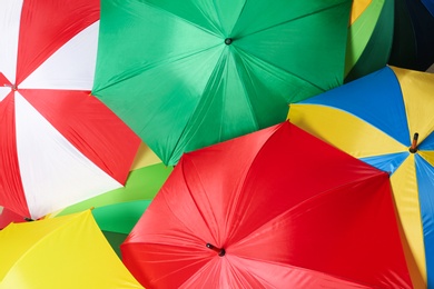 Image of Many bright umbrellas as background, top view