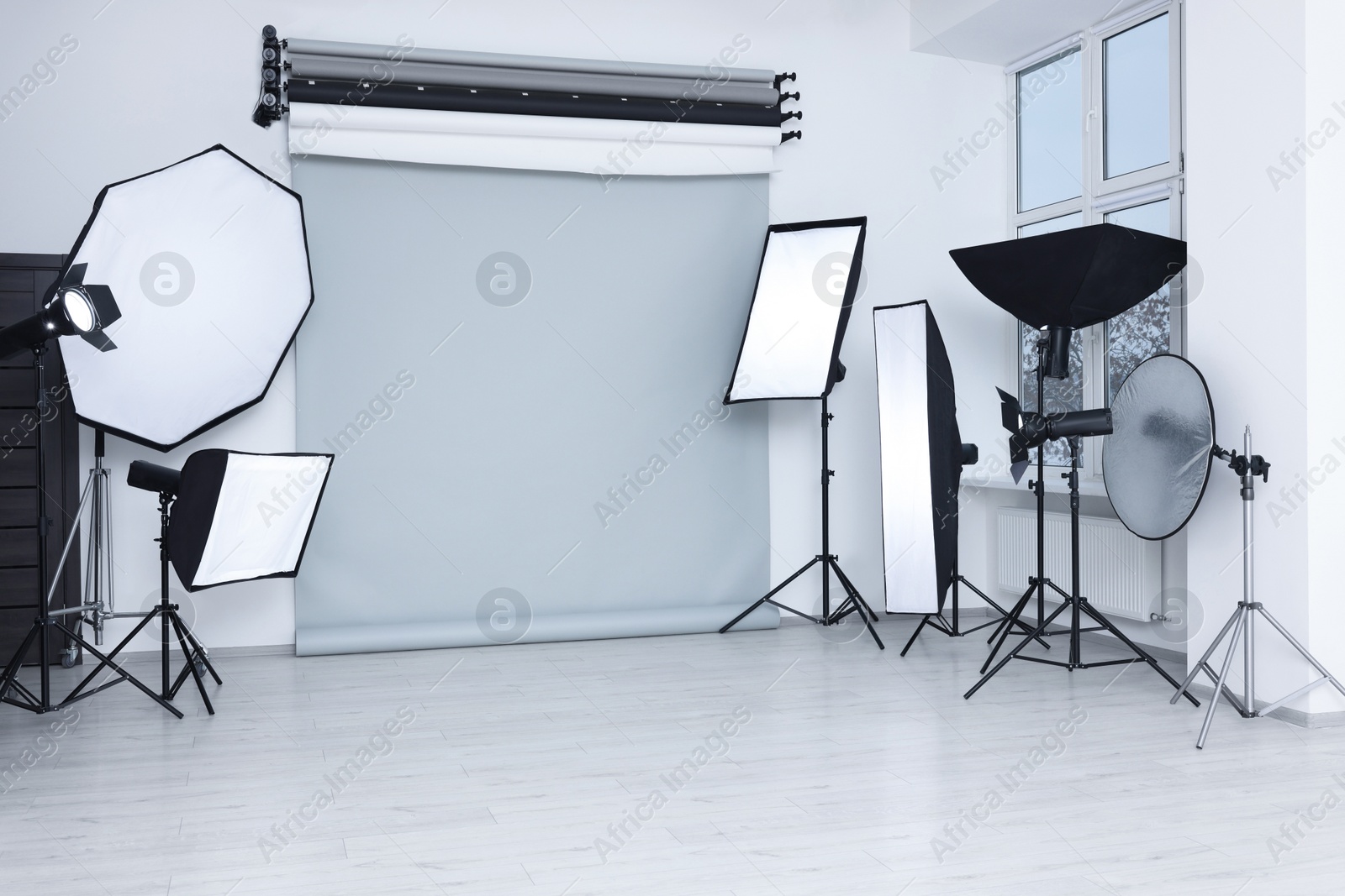 Photo of Interior of modern photo studio with professional lighting equipment