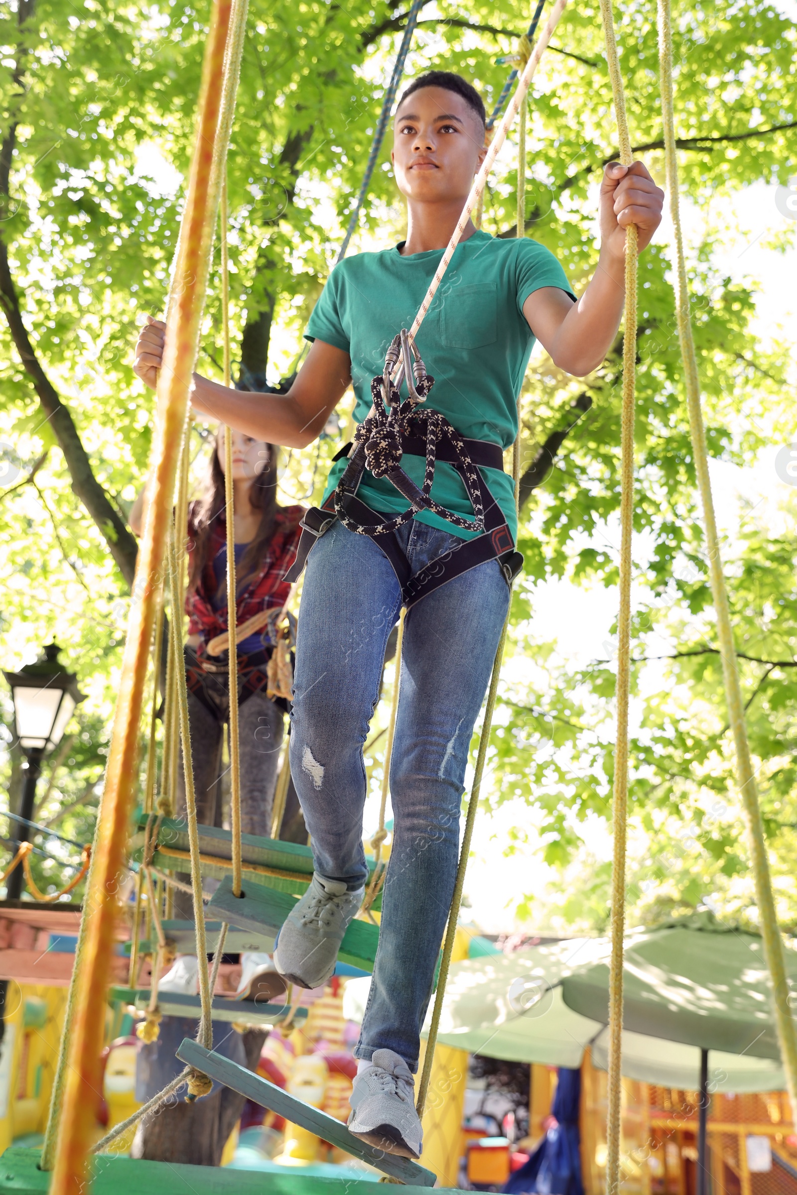 Photo of Children climbing in adventure park. Summer camp