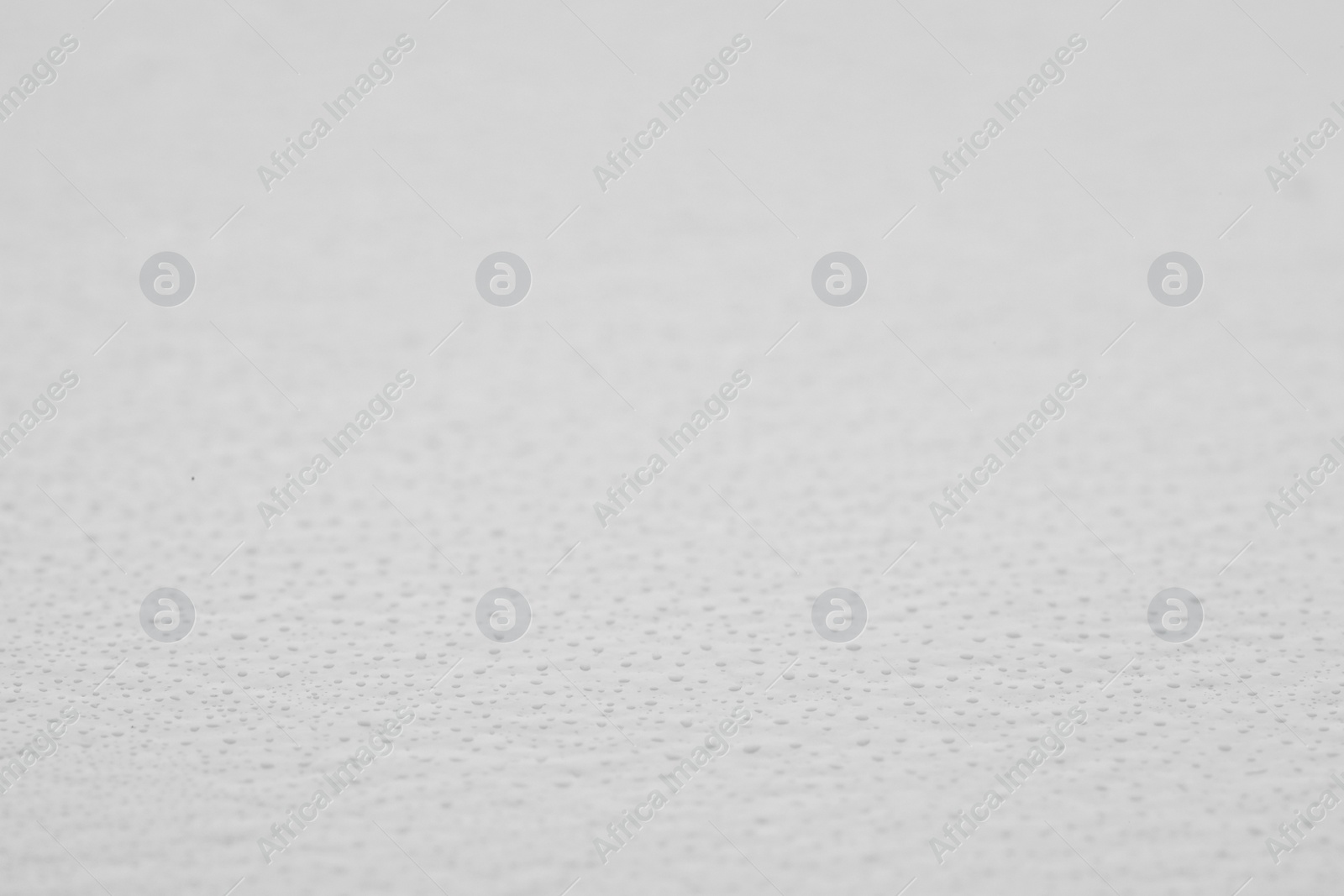 Photo of Water drops on light background, closeup view