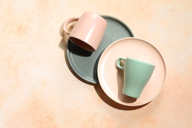 Photo of Flat lay composition with cups and plates on color textured background. Space for text