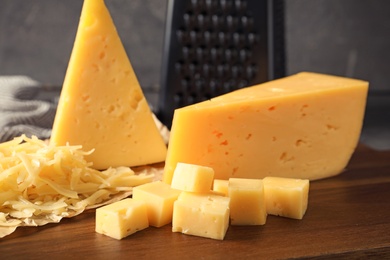 Grated and cut delicious cheese on board