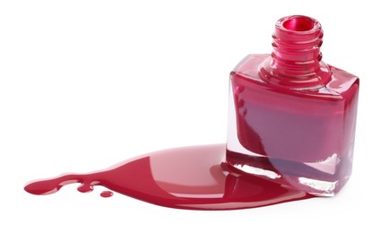 Photo of Bottle and spilled pink nail polish isolated on white