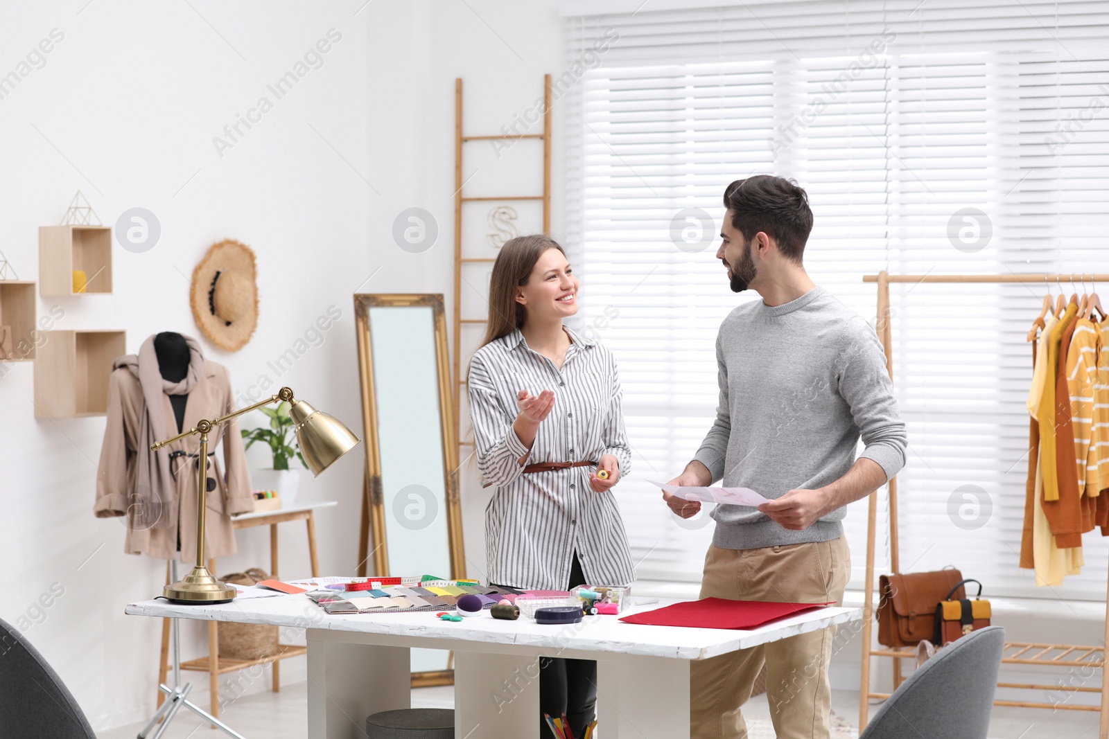 Photo of Fashion designers creating new clothes in studio