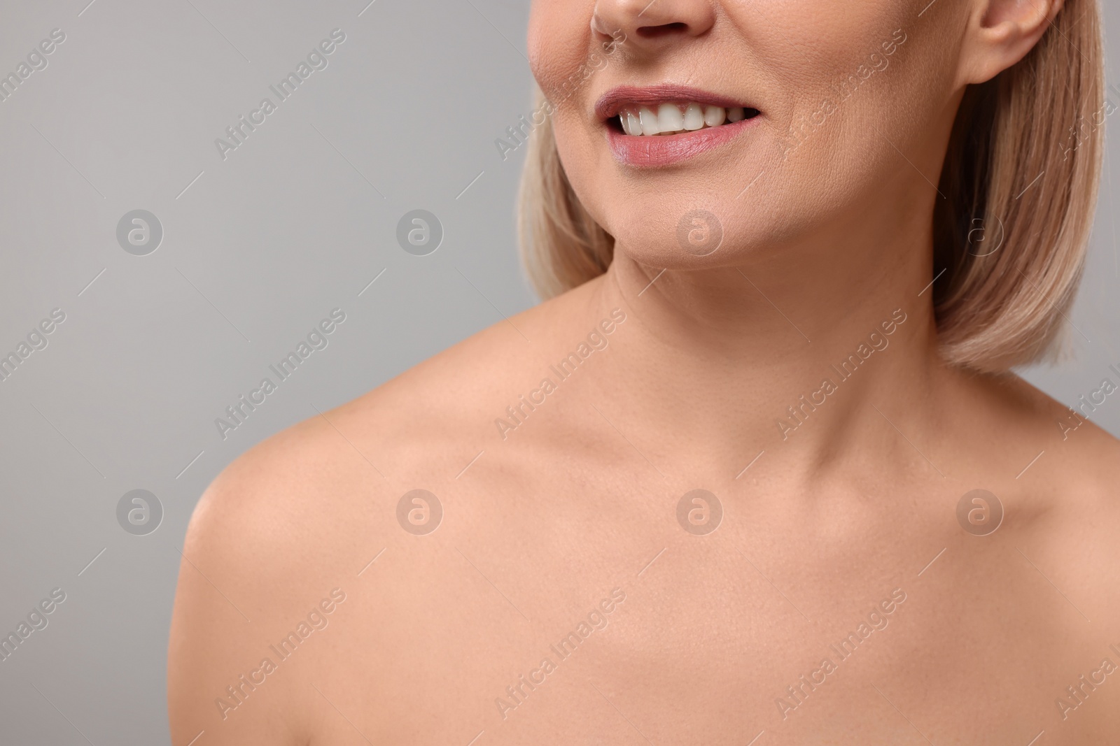 Photo of Woman with healthy skin on grey background, closeup