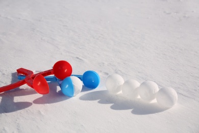 Photo of Snowballs and plastic tools outdoors on winter day