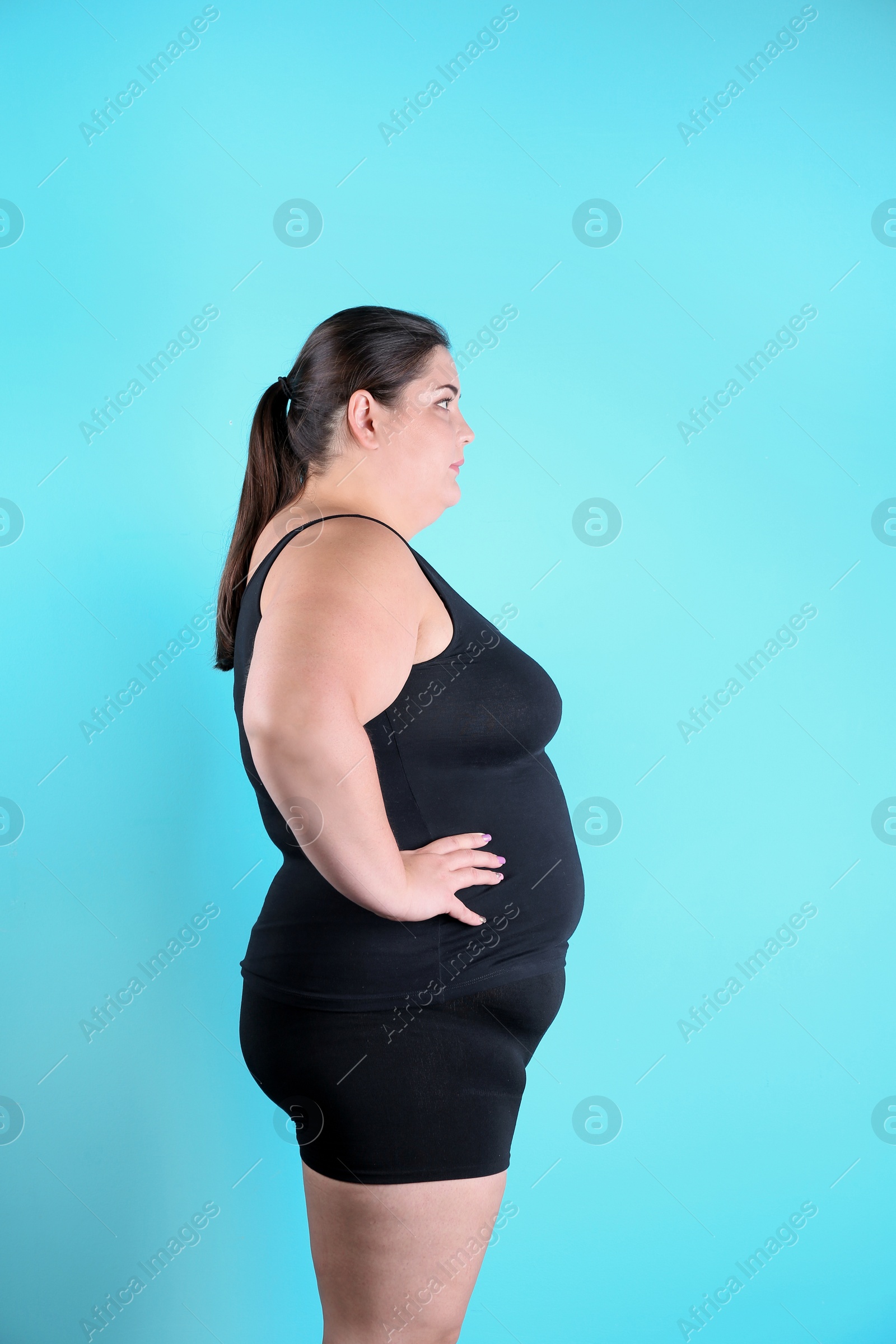 Photo of Overweight woman before weight loss on color background