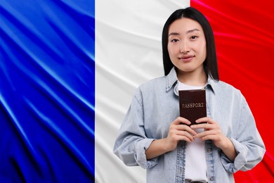 Immigration. Woman with passport against national flag of France, space for text