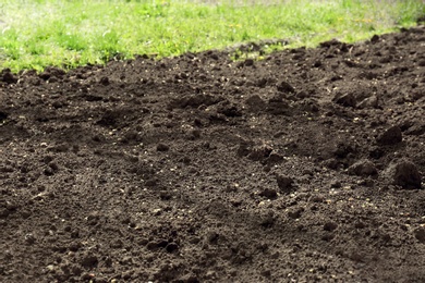 Textured ground surface as background, closeup. Fertile soil for farming and gardening