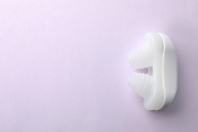 Photo of Nasal anti-snoring device on light background, top view. Space for text