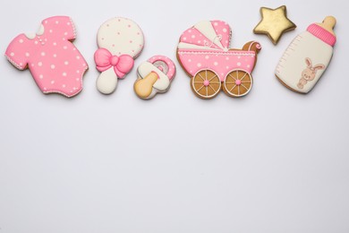 Photo of Cute tasty cookies of different shapes on white background, top view. Baby shower party