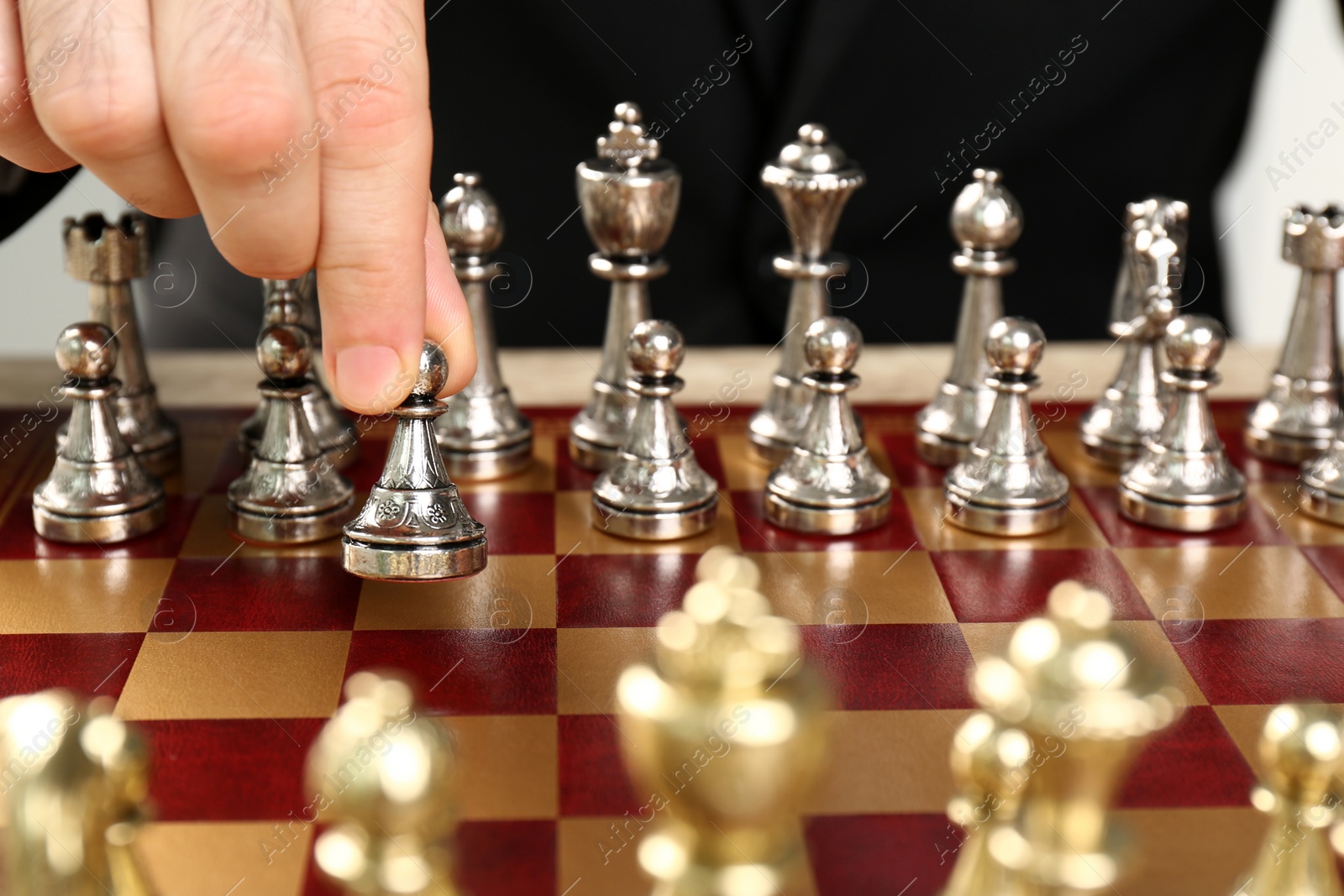 Photo of Man moving chess piece on board, closeup