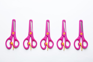 Photo of Set of training scissors on white background, top view