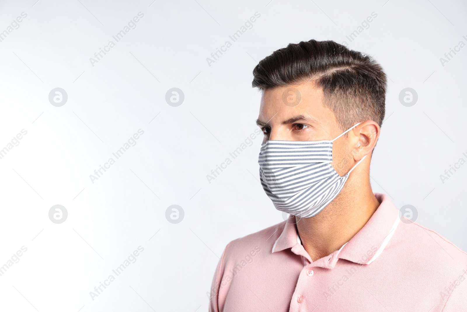 Photo of Man in protective face mask on white background