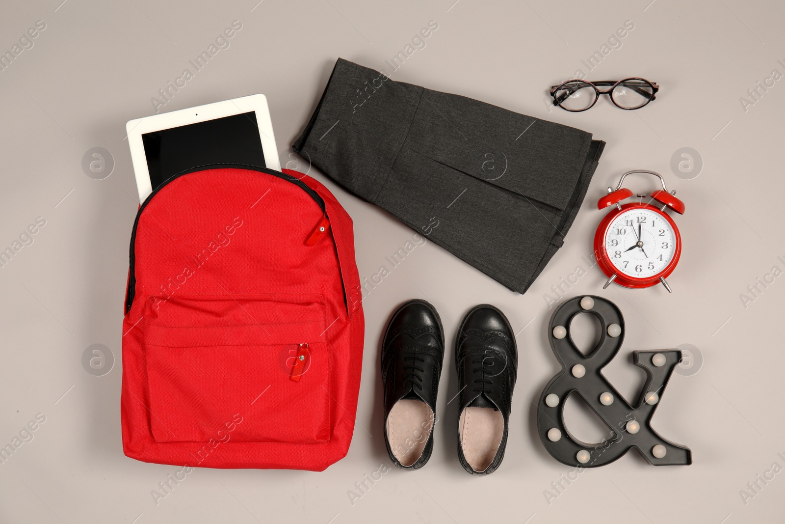 Photo of Composition with school uniform for girl on grey background, top view