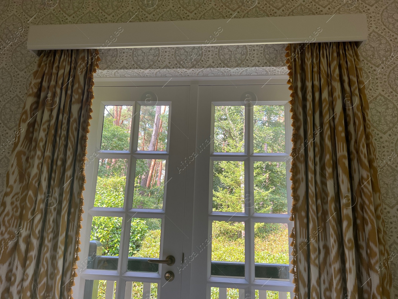 Photo of Old fashioned window with beautiful curtains in room. Interior design