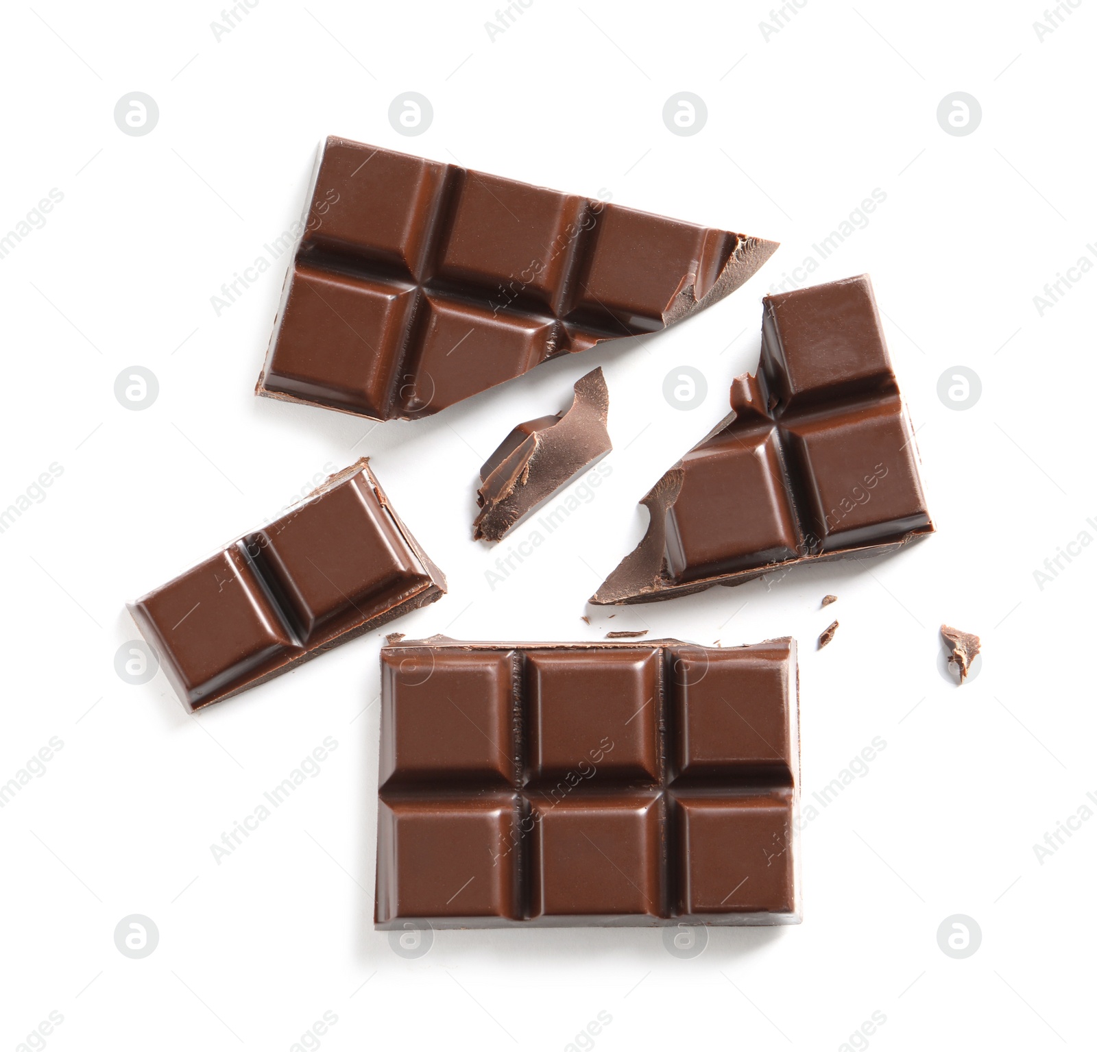 Photo of Pieces of tasty black chocolate on white background, top view