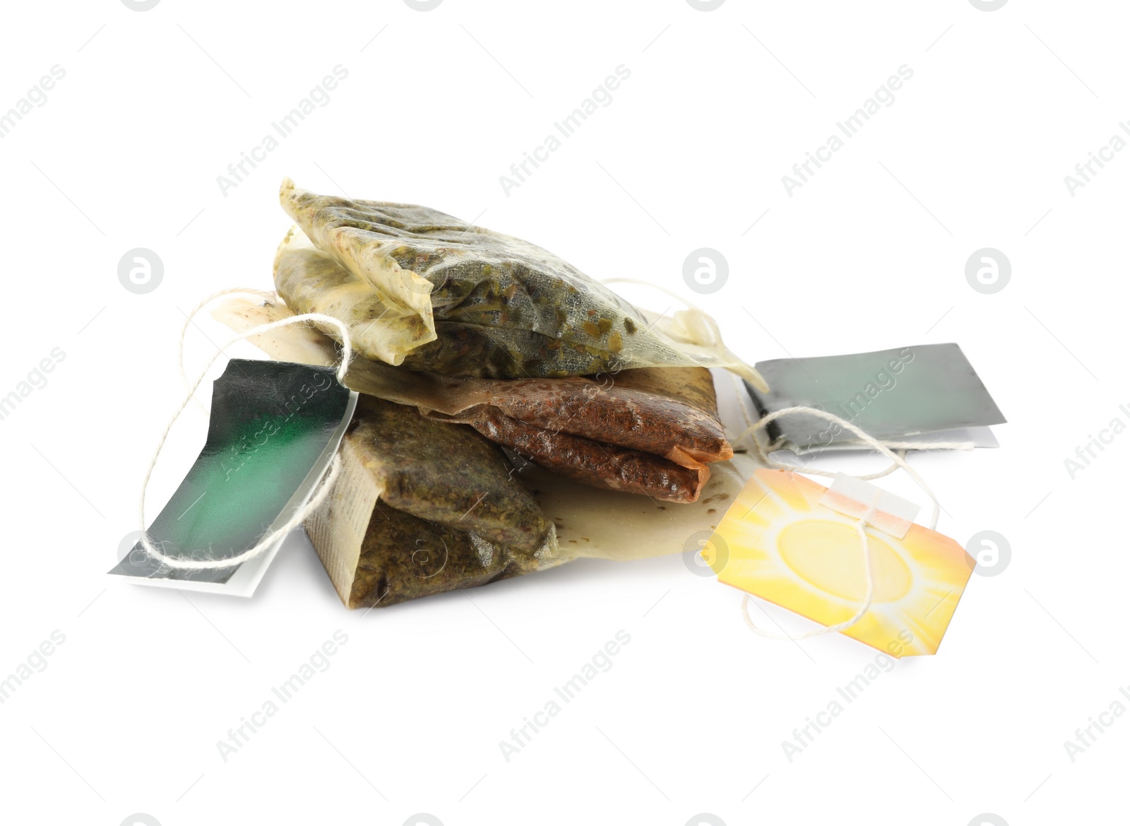 Photo of Used tea bags with tags on white background