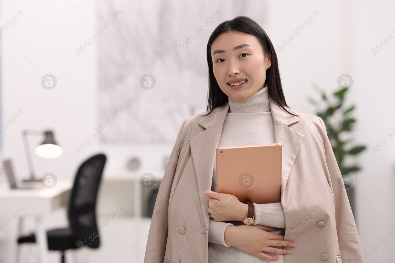 Photo of Portrait of smiling businesswoman with tablet in office. Space for text