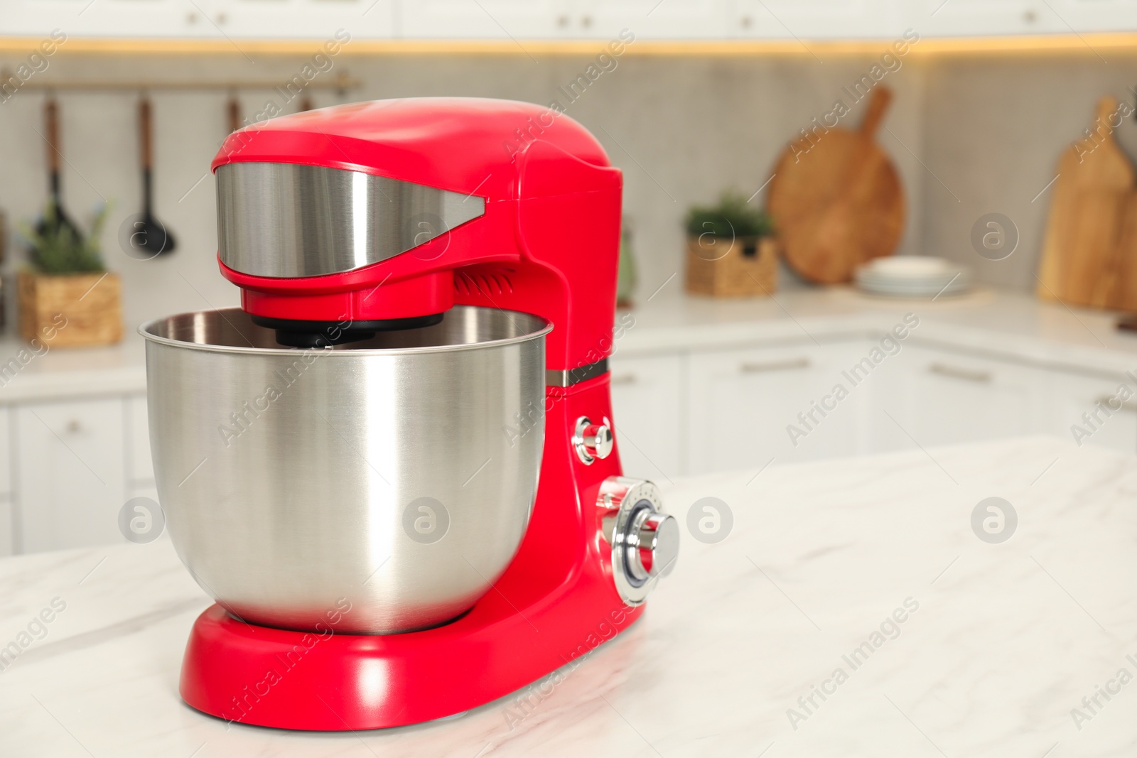 Photo of Modern red stand mixer on white marble table in kitchen, space for text