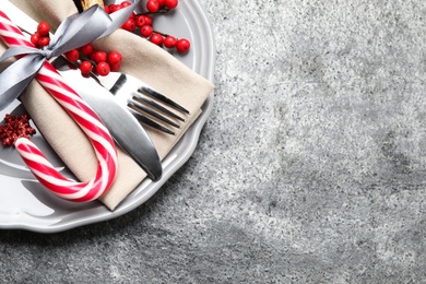 Photo of Beautiful Christmas table setting on grey background, top view. Space for text