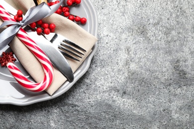 Beautiful Christmas table setting on grey background, top view. Space for text