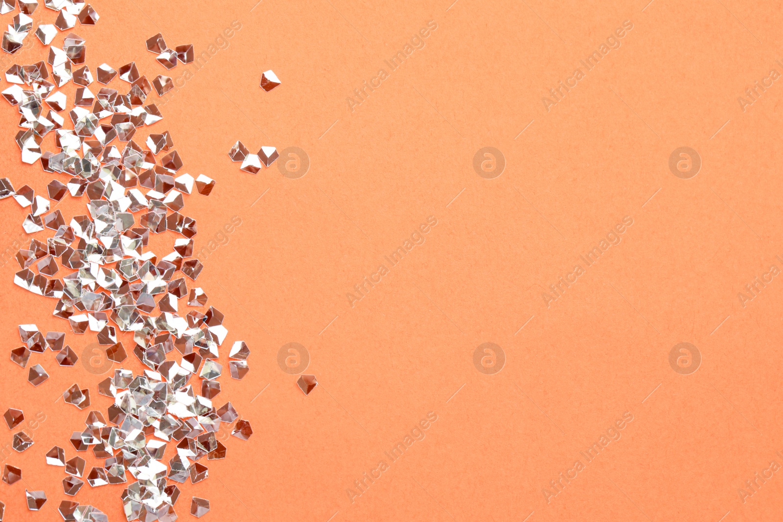 Photo of Pile of shiny glitter on pale pink background, flat lay. Space for text