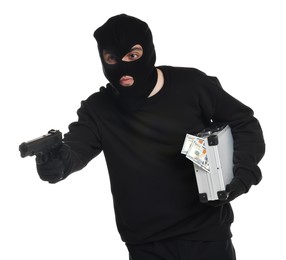 Thief in balaclava with gun and briefcase of money on white background