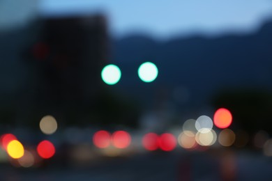 Photo of Blurred view of modern city and road with cars. Bokeh effect