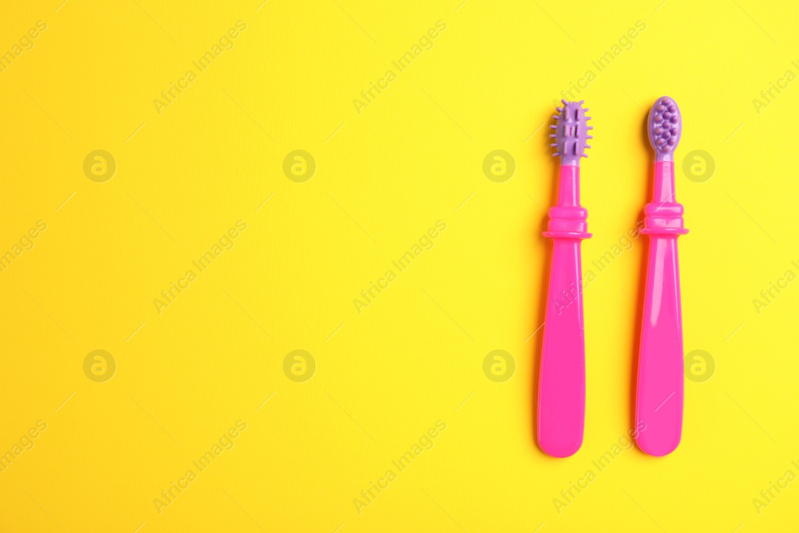 Photo of Manual toothbrushes for children on color background, top view with space for text