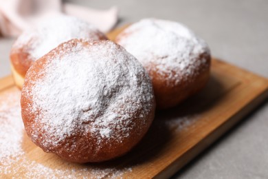 Photo of Delicious sweet buns with powdered sugar on table, closeup