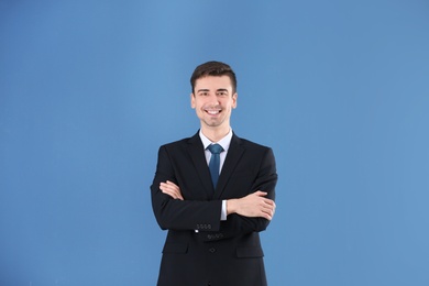 Photo of Business trainer with crossed arms on color background