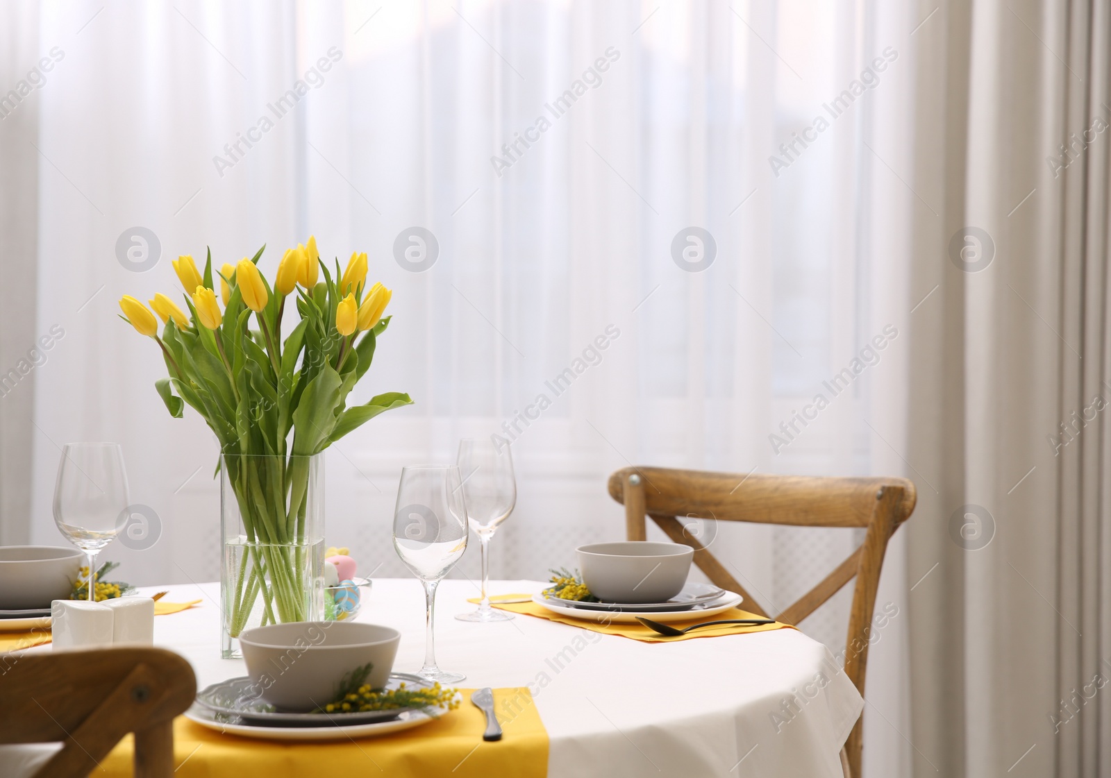 Photo of Beautiful Easter table setting with floral decor indoors