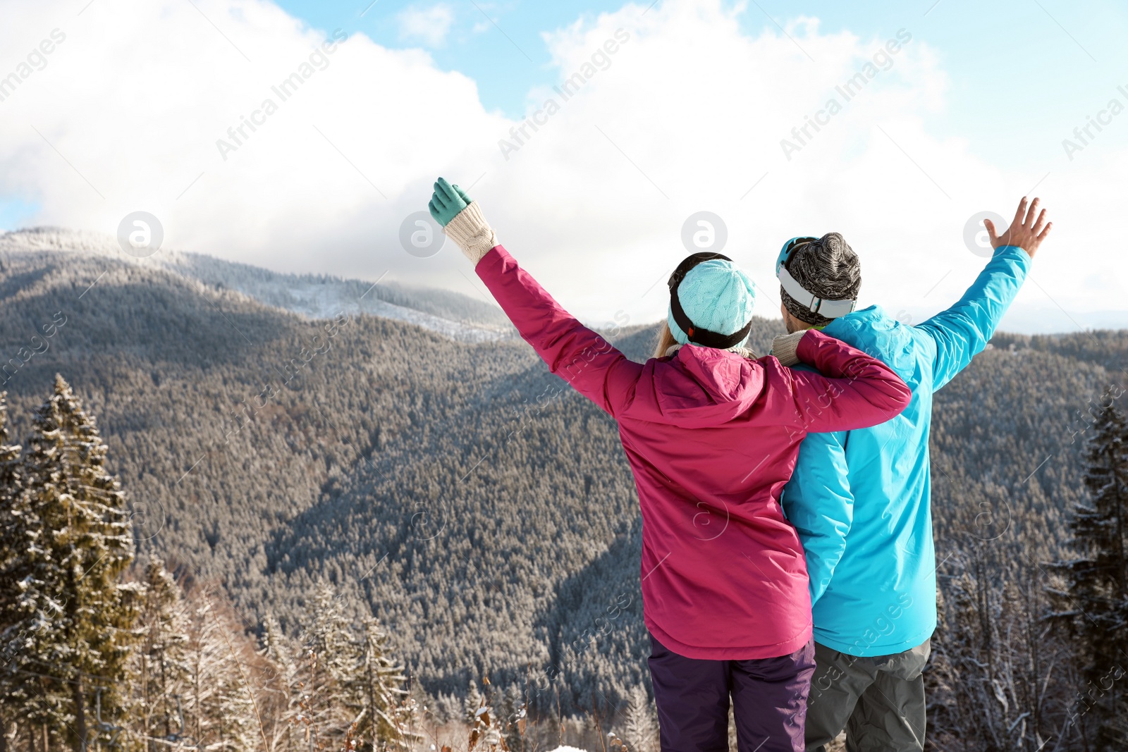 Photo of Couple spending winter vacation in mountains. Space for text