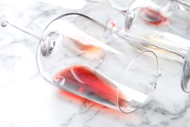 Photo of Glasses with red wine on marble background, closeup