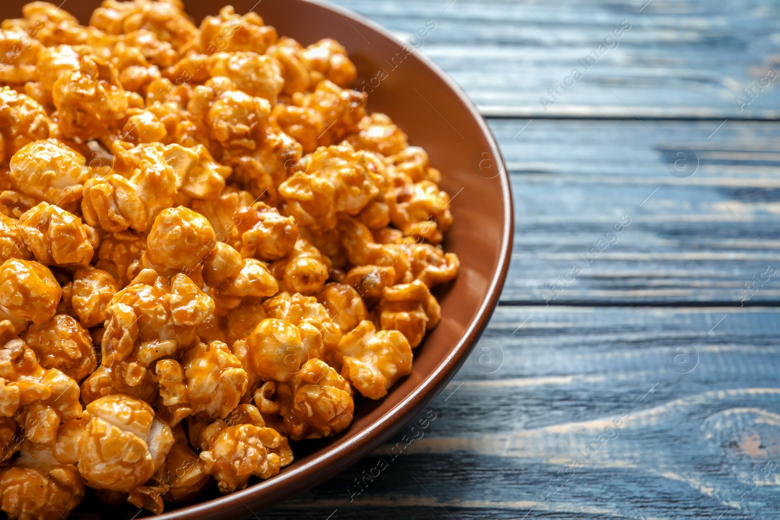 Photo of Delicious popcorn with caramel on plate