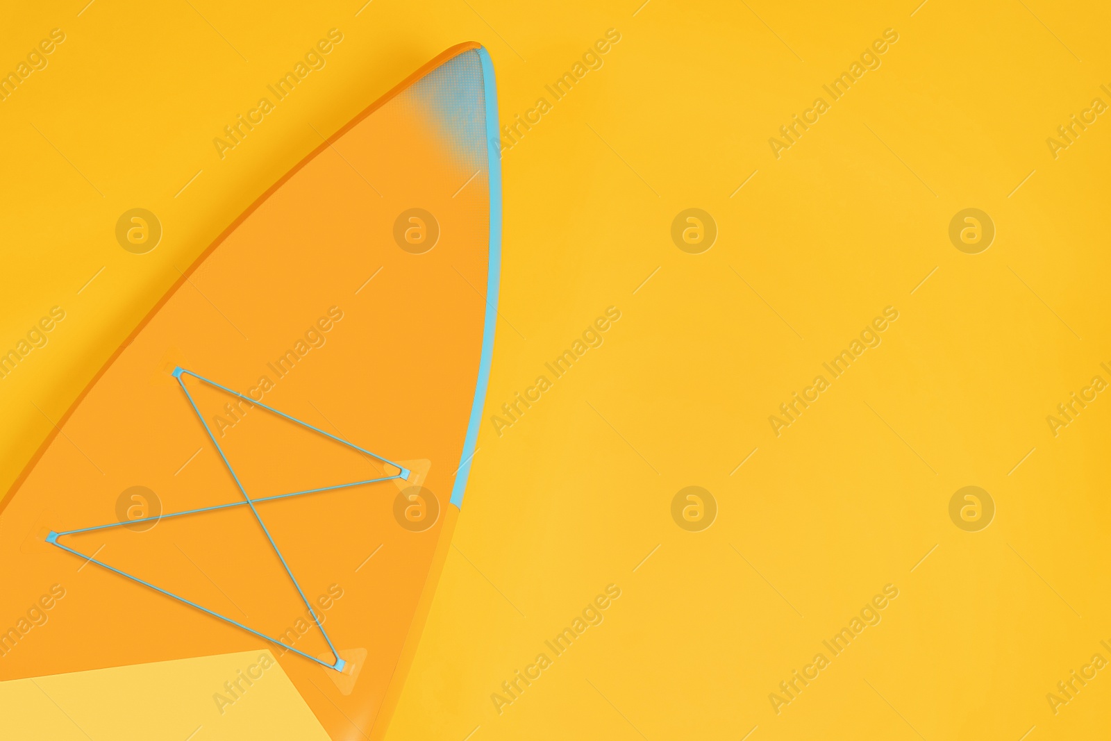 Photo of One SUP board on orange background, top view with space for text. Water sport