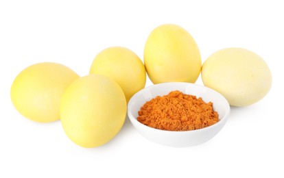 Yellow Easter eggs painted with natural dye and turmeric powder in bowl on white background