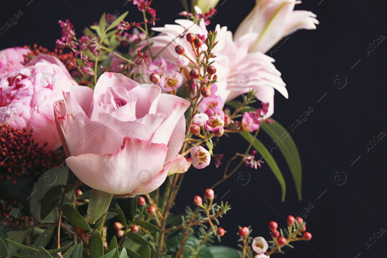 Photo of Beautiful bouquet of different flowers on black background, closeup. Floral card design with dark vintage effect