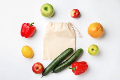 Photo of Cotton eco bag, fruits and vegetables on white background, top view