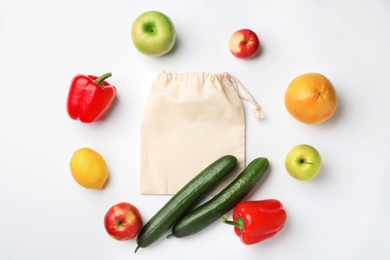 Cotton eco bag, fruits and vegetables on white background, top view