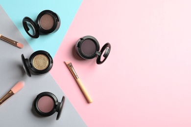 Photo of Flat lay composition with different eye shadows on color background. Space for text