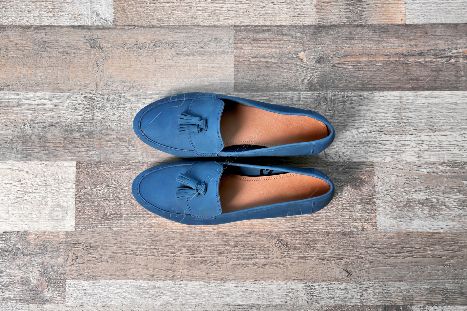 Photo of Pair of female shoes on wooden background, top view