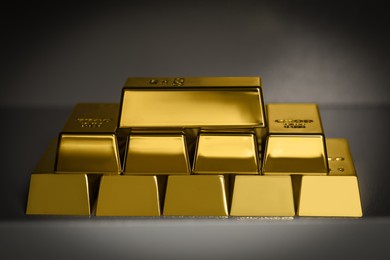 Photo of Many gold bars on light grey table