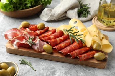 Delicious charcuterie board served on light grey table