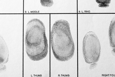 Photo of Police form with fingerprints, top view. Forensic examination