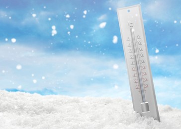 Thermometer in snow showing temperature below zero outdoors on winter day