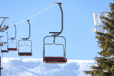 Photo of Empty chairlift at mountain ski resort. Winter vacation